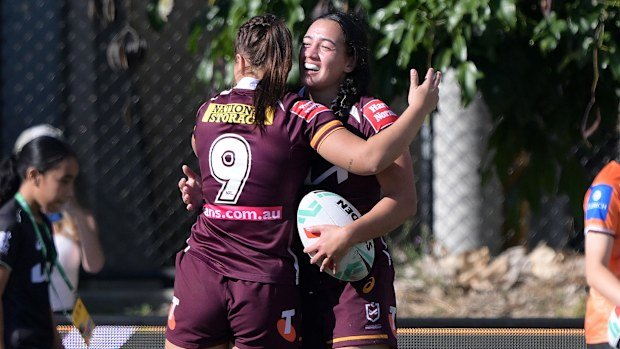 Kerri Johnson celebrates scoring a try on her NRLW debut.