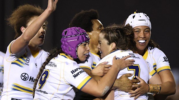 The Eels' Rachael Pearson celebrates with teammates after scoring a try against the Sharks.