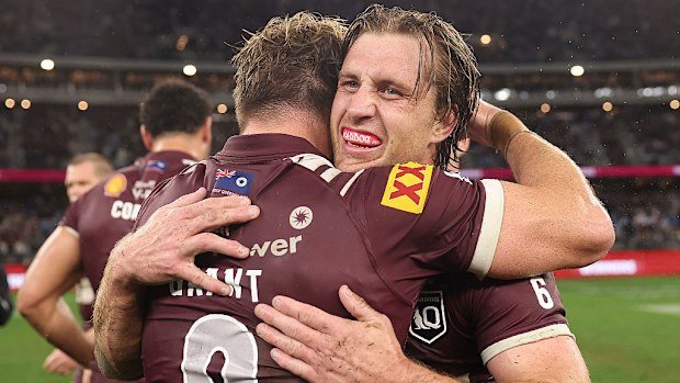 Cameron Munster and Harry Grant embrace after winning the second game of the 2025 State of Origin series.