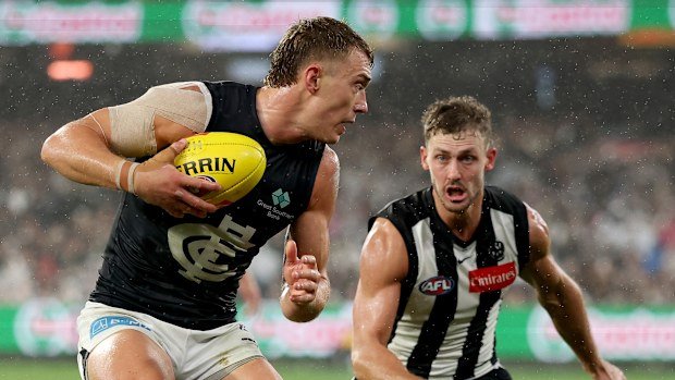 Patrick Cripps of the Blues dodges a tackle from Harry Perryman of the Magpies.